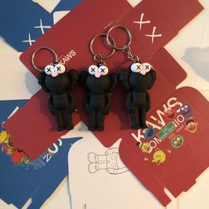 3 black kaws with boxes